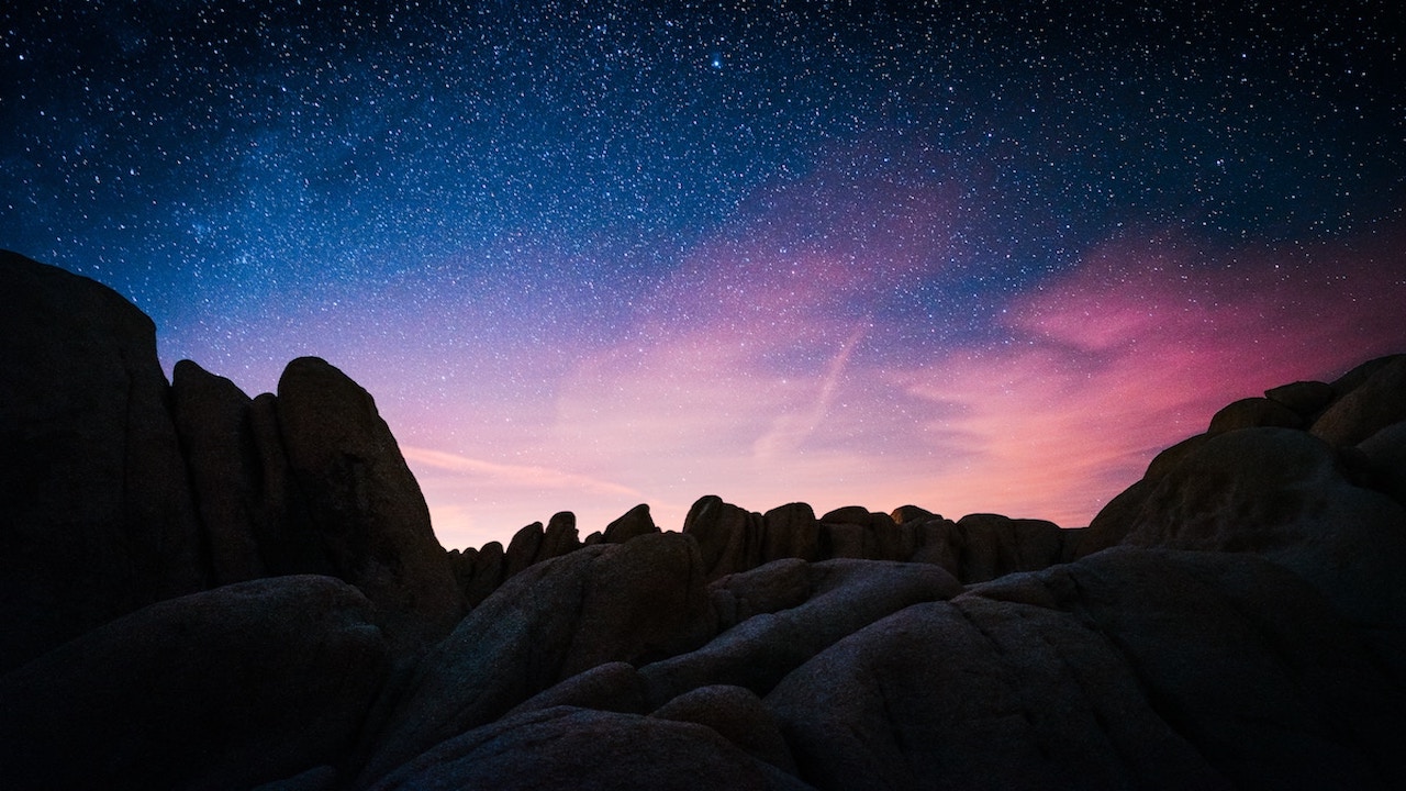 rock mountain during starry night